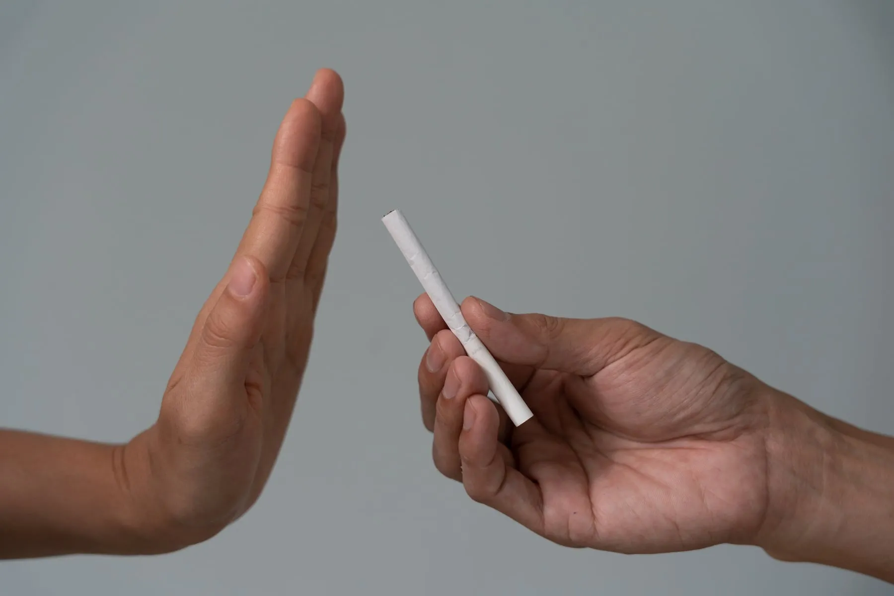 Une main refusant un paquet de cigarettes